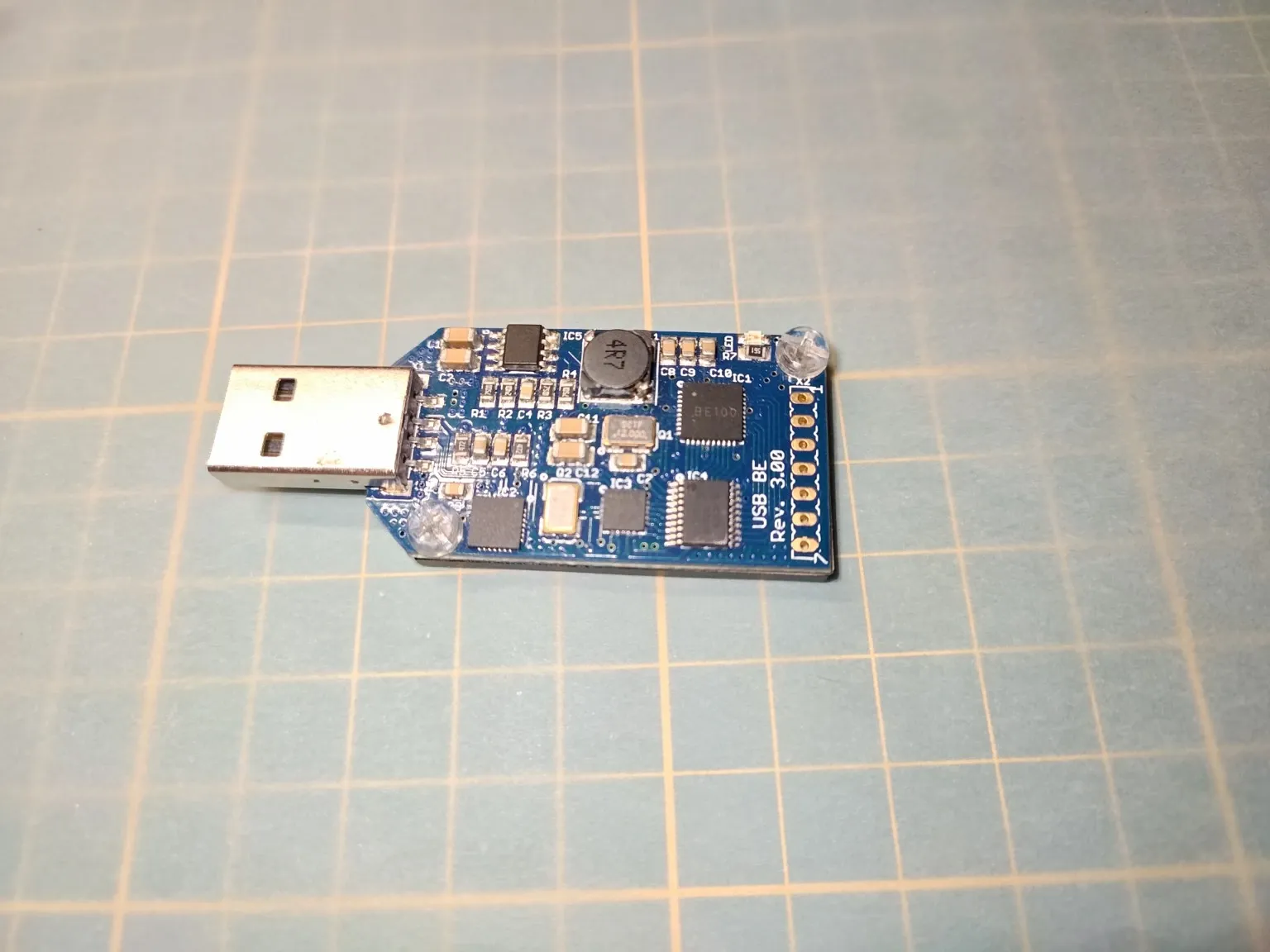 Otevřený ASICMiner Block Erupter Sapphire, modrá deska plošných spojů a součástky kolem USB konektoru.